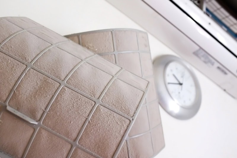 Ductless Maintenance. Photo of a dirty air condition filter.|Ductless Maintenance. Photo of a dirty air condition filter.