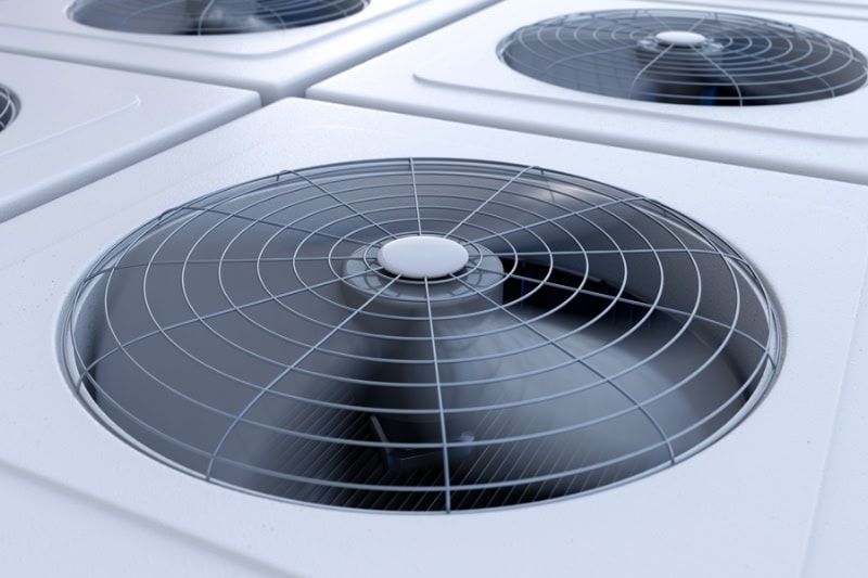 3 Telltale Signs It’s Time for a New AC - Close up image of HVAC system units with fans. Heating